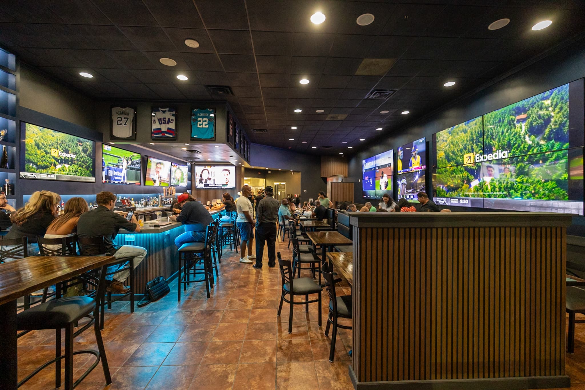 The Owner's Box bar interior with wall-to-wall screens